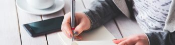 Woman, write, notepad — How Dr. Andrew Gomes Is Transforming Neuroimaging Practices
